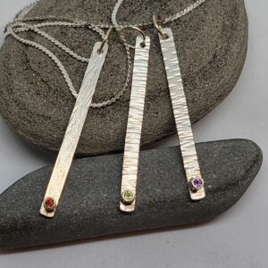 Textured sterling silver pendants with tube set gemstones